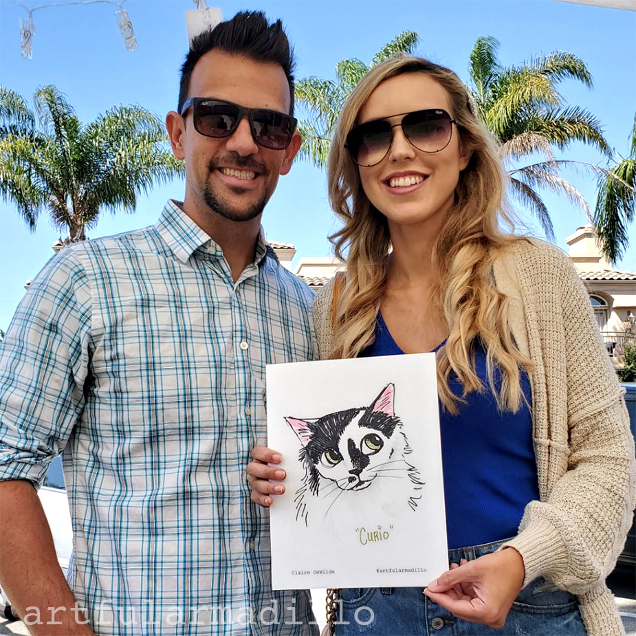 A couple shows off their cat caricature